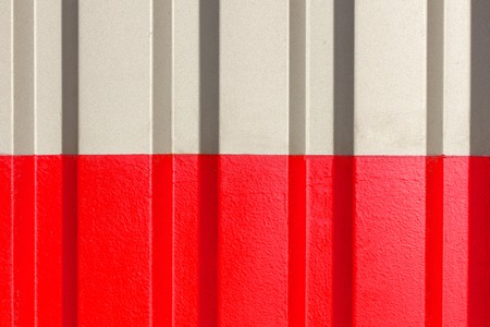 The two halves grey and red of the figure of corrugated texture. Concept: reliable, abstract, creative, art, fence.の写真素材