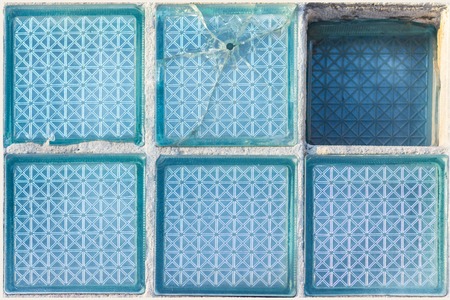 Decorative and glossy glass block window in blue as a texture or for background. Broken place. The wall. Geometric background.の写真素材