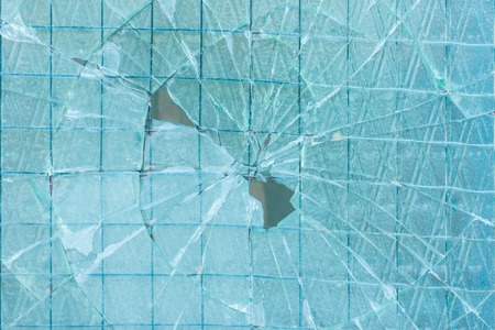 Broken decorative and glossy glass block window as a texture or for background. The wall. Geometric...