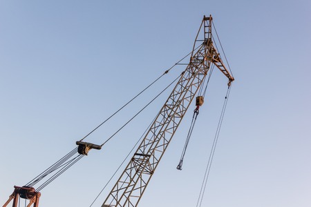 Tower crane on a construction site at sunriseの写真素材