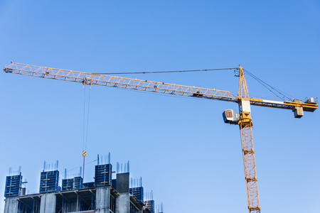 A new building is being constructed with use of tower crane.の写真素材