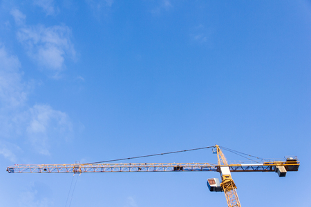 High tower crane against the blue skyの写真素材