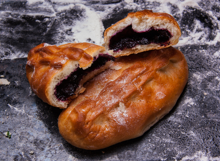 Savory stuffed patties on black baking tray. Country house style. Authentically.の写真素材