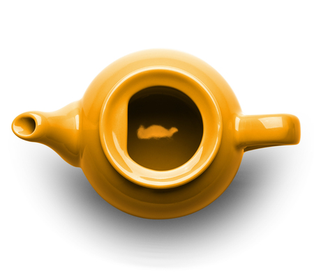 Orange ceramic teapot without a lid isolated on white background, top viewの写真素材
