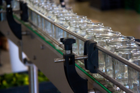 Working process of the production of cucumbers on cannery. Packaging line for processing cucumbers...