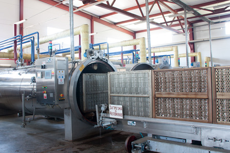 Working process of the production of green peas on cannery. Pasteurization in autoclave.