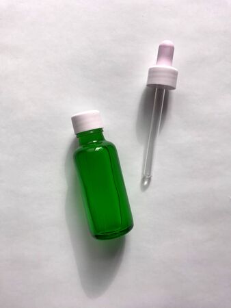 bubble with serum and a dropper in the sunlight. cosmetics for careの写真素材