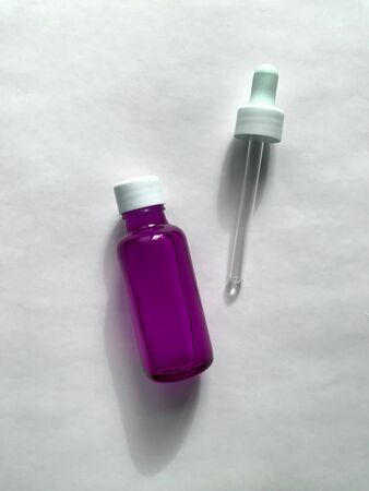 bubble with serum and a dropper in the sunlight. cosmetics for careの写真素材