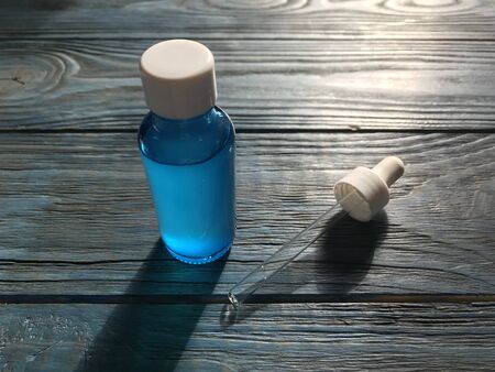 bubble with serum and a dropper in the sunlight. cosmetics for careの写真素材