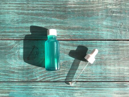 bubble with serum and a dropper in the sunlight. cosmetics for careの写真素材