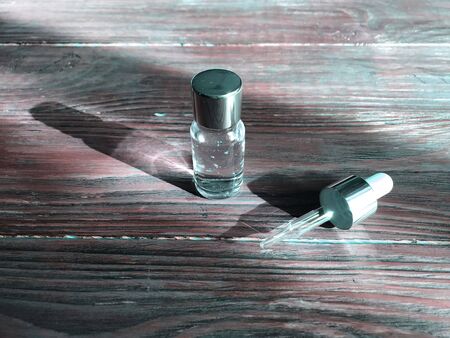 bubble with serum and a dropper in the sunlight. cosmetics for careの写真素材