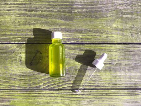 bubble with serum and a dropper in the sunlight. cosmetics for careの写真素材