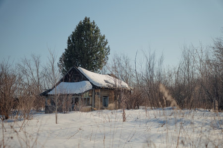 Abandoned wooden house in winter. Old abandoned house in winter.の写真素材