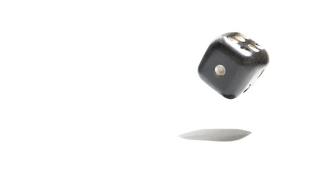 Black dice isolated on white background with copy space for your text.