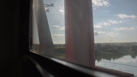 View from the window of a passenger train moving along the river.の写真素材