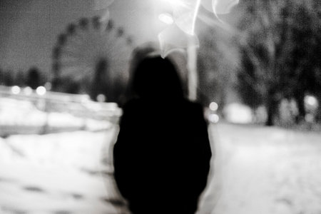 blurred silhouette of a person on a background of the night city
