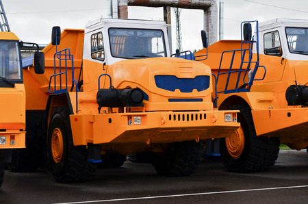 Low yellow dump truck for transportation of rock mass and minerals in underground workings, tunnels and other cramped conditions. Special equipment. Mining, careerの写真素材