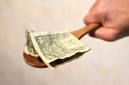 Prepayment service gratitude concept. Salary. American bills, dollars in a wooden spoon