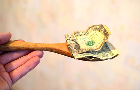 Prepayment service gratitude concept. Salary. American bills, dollars in a wooden spoonの写真素材