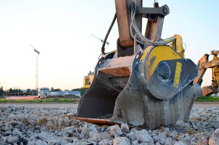 Crushing bucket of the excavator for crushing concrete. Construction waste recycling for...