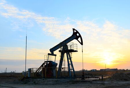 Oil drilling derricks at desert oilfield. Crude oil production from the ground. Oilfield services...
