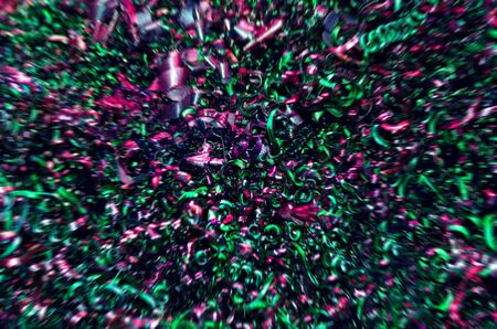 Colored metal twisted spiral in the form of chips obtained as a result of processing metal products on a turning industrial CNC machine tool. Steel shavings, with a blurred background.の写真素材