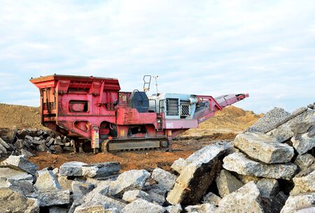 Mobile Stone crusher machine by the construction site or mining quarry for crushing old concrete...