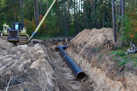 Natural gas pipeline construction work. Trench in the ground for the installation and installation...