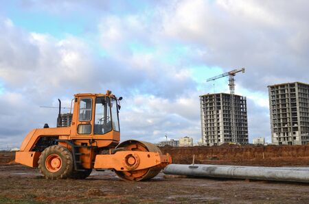 Vibration single-cylinder road roller leveling the ground for the construct of the foundation for...