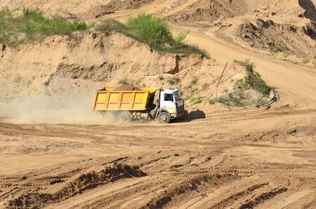 Dump truck transports sand and other minerals in the mining quarry.