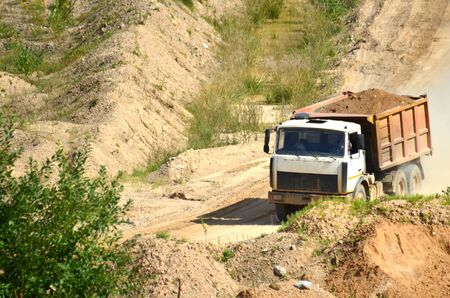Dump truck transports sand and other minerals in the mining quarry.