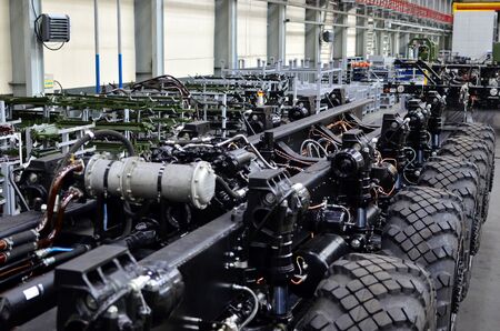 Industrial workshop for the production of trucks, wheel chassis and vehicles. Lightweight fixed frame air suspension, air springs and shock absorbers. Truck suspension and steering linkage.の写真素材