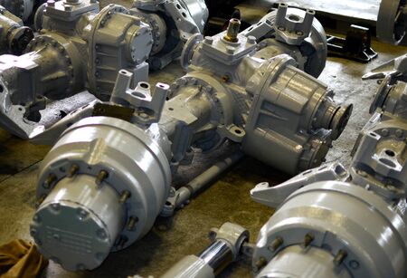 1st driven frontaxle for truck with transmission. Industrial workshop for the production of trucks, wheel chassis and vehicles. Air suspension, gearbox, springs and shock absorbers. Steering linkageの写真素材