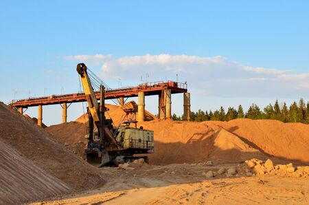 Huge mining excavator in the limestone open-pit. Biggest digger working in dolomite quarry. Largest...