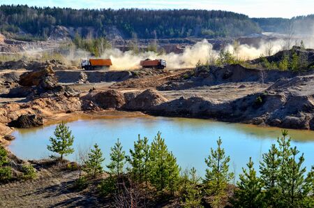 Mining dump truck transports sand and other minerals in the quarry.