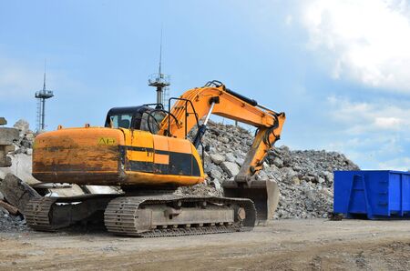 Excavator at Industrial landfill for the processing of old, old concrete structures. Crushing and...