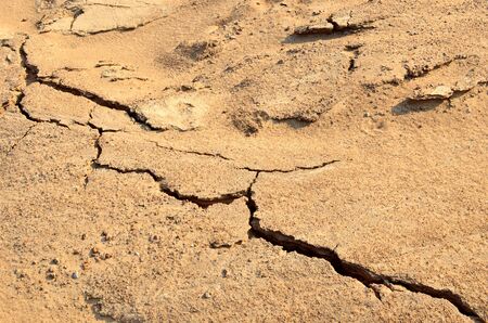 Dry lake or swamp in the process of drought and lack of rain or moisture, a global natural disaster. The cracked soil of the earth due to climate change. Background or texture of sand in mining quarryの写真素材
