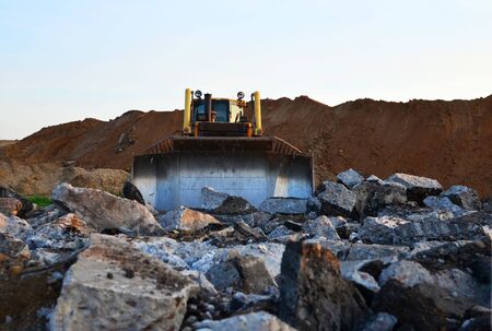 Track-type bulldozer, earth-moving equipment. Land clearing, grading, pool excavation, utility trenching, utility trenching and foundation digging during of large construction jobs.の写真素材