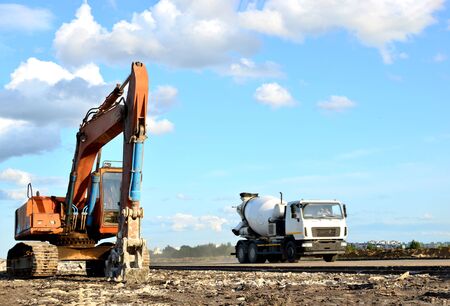 Excavator with hydraulic shears breaks asphalt on a construction site. Hydraulic shear crusher...