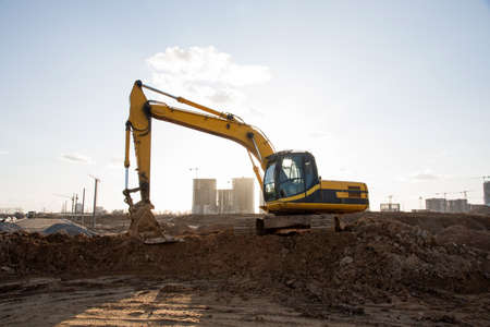Excavator digs at construction site