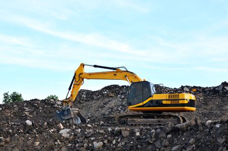 Excavator with crusher bucket for crushing concrete. Construction waste recycling for construction...