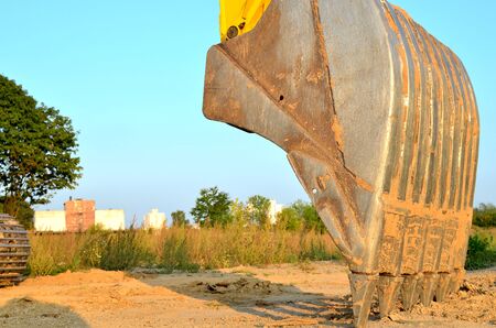 Large metal iron ladle. Excavator bucket for digging a pit and pipeline ditch at a construction...