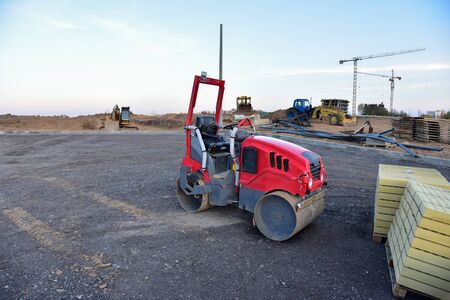 Paving roller machine during road work. Mini road roller at construction site for paving works....