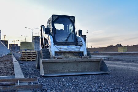 Bobcat skid-steer loader for loading and unloading works on city streets. ompact construction...