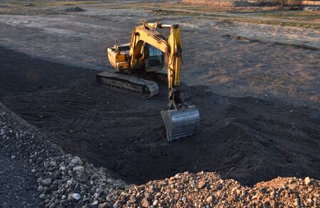 Excavator working on earthmoving at open pit mining. Backhoe digs gravel in quarry. Construction...