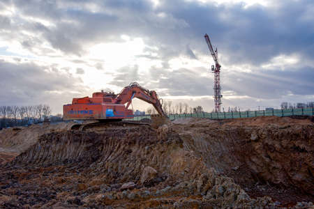 Minsk, Belarus, April 02, 2020: Tracked excavator KRANEKS working at a construction site. Construction machinery for excavating, loading, lifting and hauling of cargo on job sitesのeditorial素材