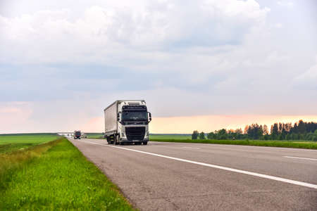 BELARUS, MINSK, JUNE 10, 2020: VOLVO FH truck with Semi-trailer driving along highway on sunset background. Goods Delivery by roads. Services and Transport logistics. Object in motion, soft focusのeditorial素材