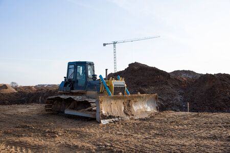 Dozer during roadwork at construction site. Bulldozer for land clearing, grading, pool excavation, utility trenching and foundation digging. Heavy machinery and earth-moving equipmentの写真素材