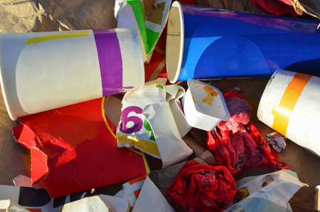 People throw coffee cups on snow. A pile of abandoned garbage on the street. Scattered food waste,...
