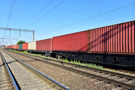 Cargo Containers Transportation On Freight Train By Railway. Intermodal Container On Train Car. Rail...